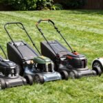 Various types of lawn mowers lined up on a freshly cut lawn, showing gas, battery, and robotic options